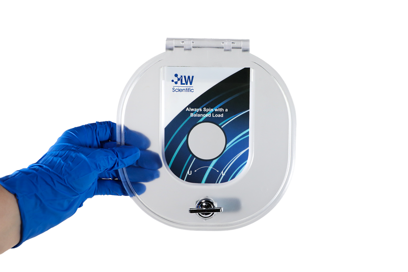 Blue-gloved hand holding a clear protective lid for the LW Scientific E8 centrifuge.