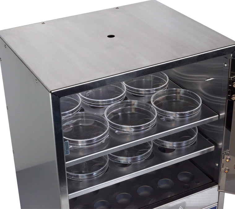 laboratory incubator with open door and multiple petri dishes arranged on interior shelves.